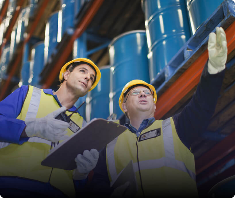 two men in hard hats at a factory